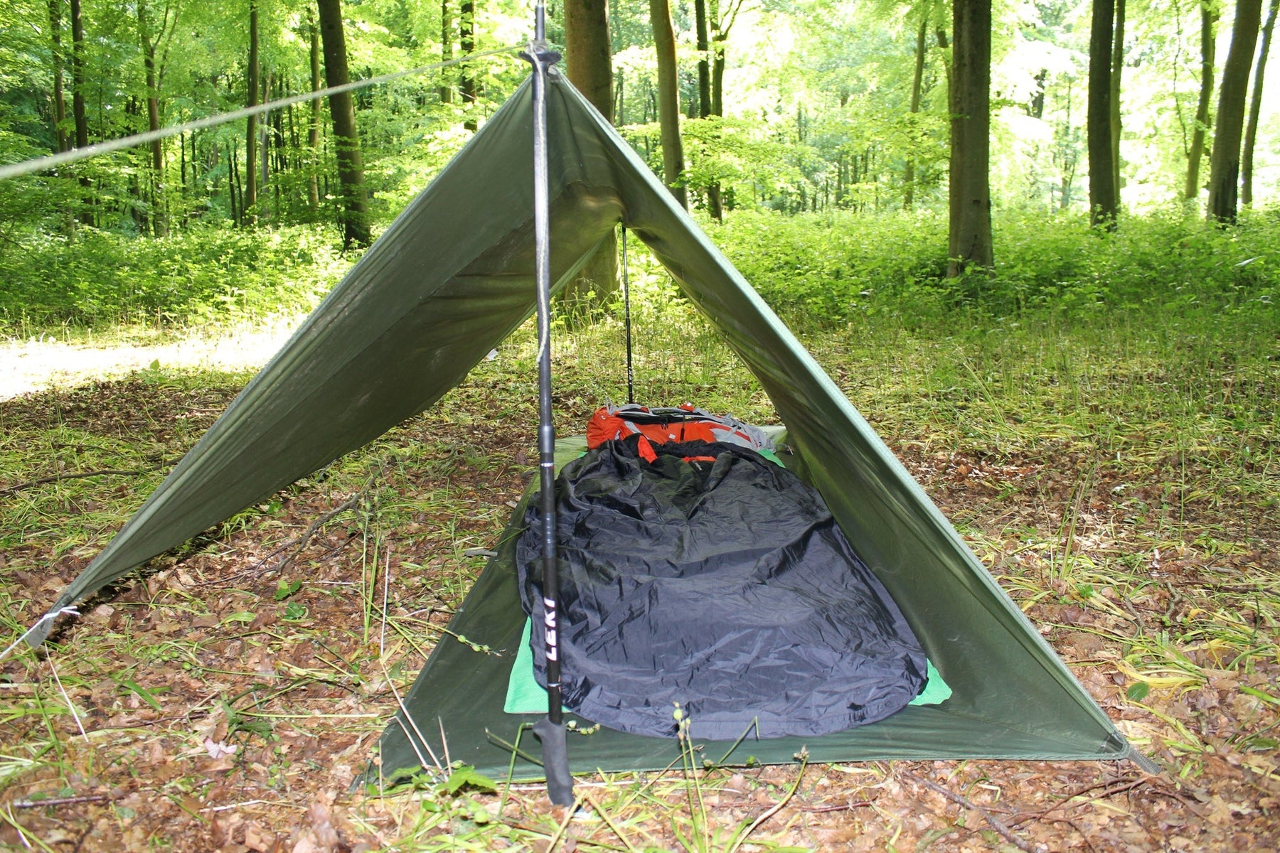 All weather shelter erected with sleeping equipment inside